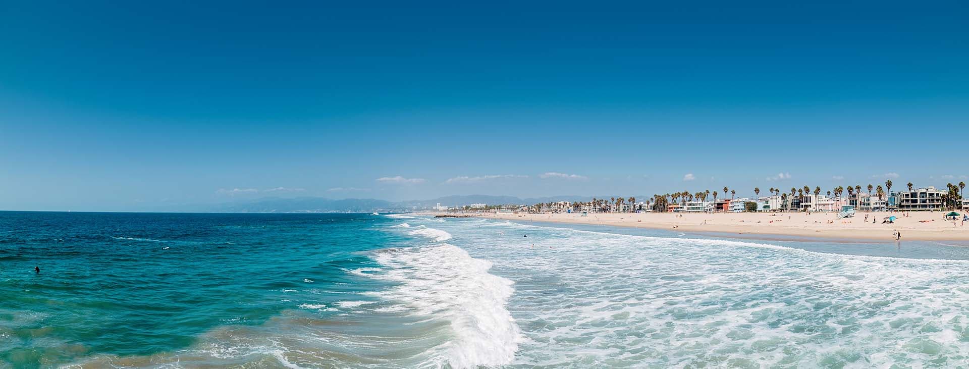 Pacific ocean coastline in Los Angeles USA. People walking at th